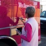 10659410_822932077740642_5041820781460005395_n: Breast Cancer Survivor signing her name to the firetruck