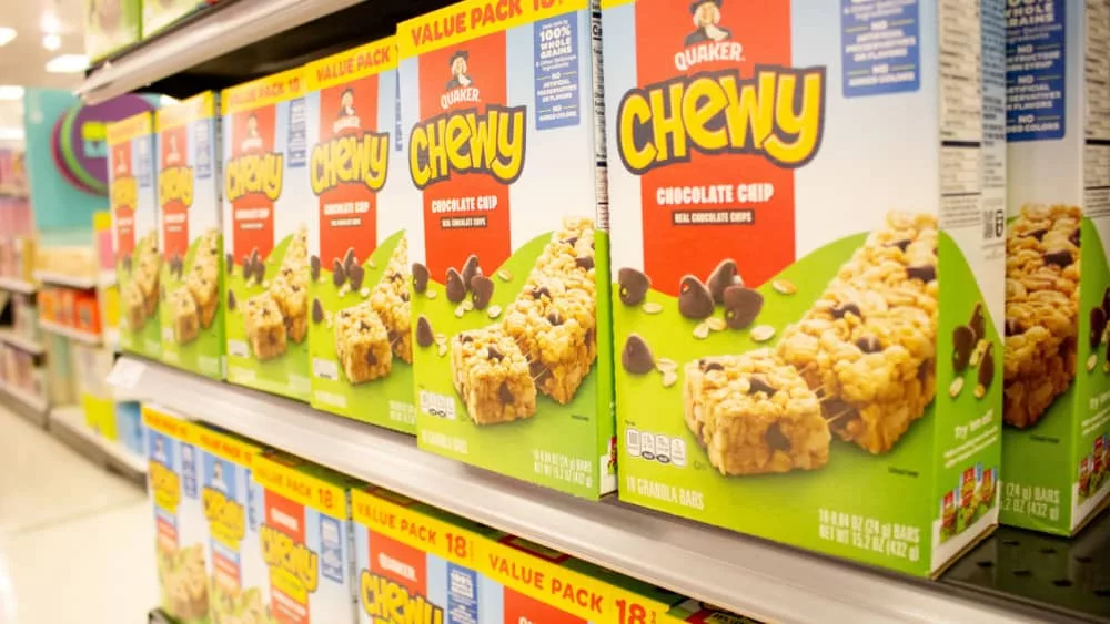 A view of several boxes of Chewy chocolate chip granola bars^ on display at a local grocery store.