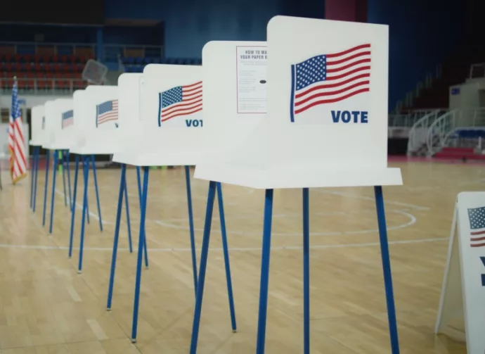 Voting booths with American flag logo at polling station. National Election Day in the United States of America.