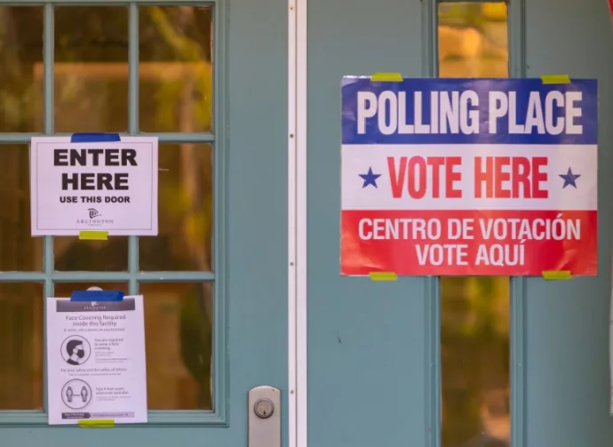 Signs on polling place door during voting on presidential election day in northern Virginia. ARLINGTON^ VIRGINIA^ USA - NOVEMBER 3^ 2020