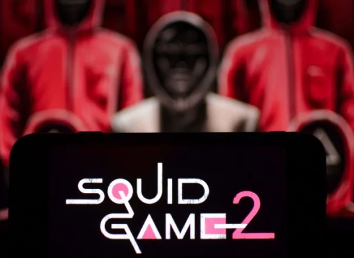 Squid Game 2 (Ojingeo geim) logo displayed on smartphone screen. This is a new Netflix series.