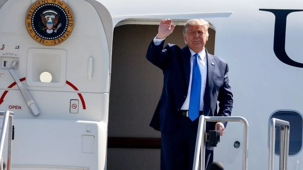 President Donald Trump waves as he steps off Air Force One at John Wayne Airport^ Santa Ana^ Calif.^ on Sunday Oct. 18^ 2020.