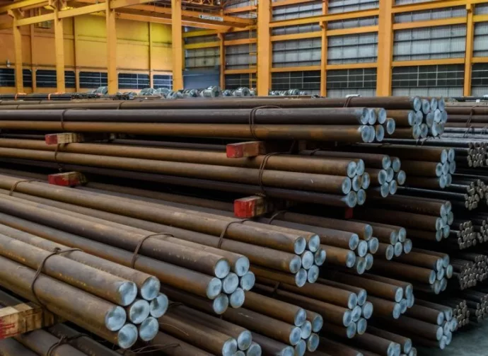 Rows of Steel Round Bar storage and stacking in the warehouse for industrial construction.
