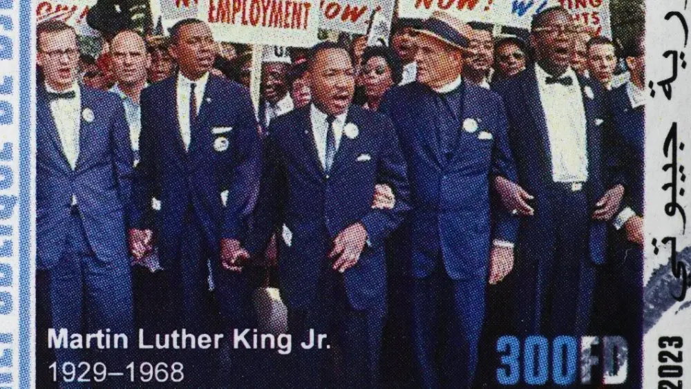 Martin Luther King during a protest march on postage stamp Milan^ Italy – January 7^ 2024