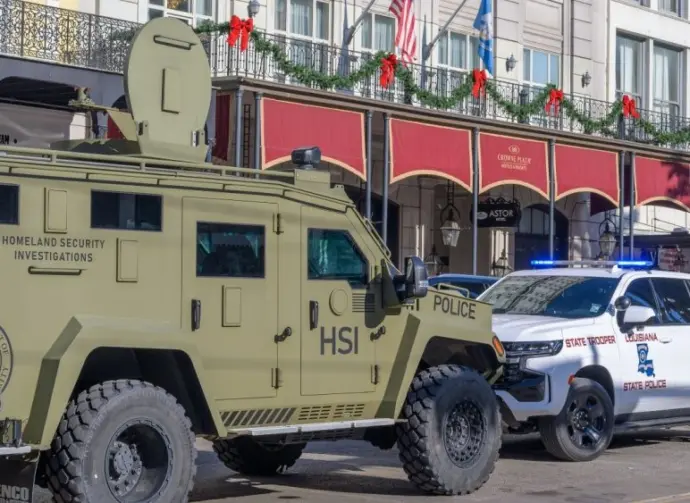 City police^ state police and Homeland Security officers^ and an armored vehicle and state patrol vehicle on Canal Street near the entrance to Bourbon Street New Orleans^ LA^ USA - January 2^ 2025