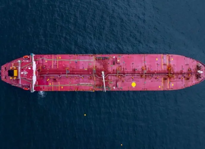 Aerial view crude oil tanker ship at sea^ Red crude oil tanker ship top view^ Logistic and maritime transpoprtation of petroleum^ Modern offshore terminal loading tanker ship.
