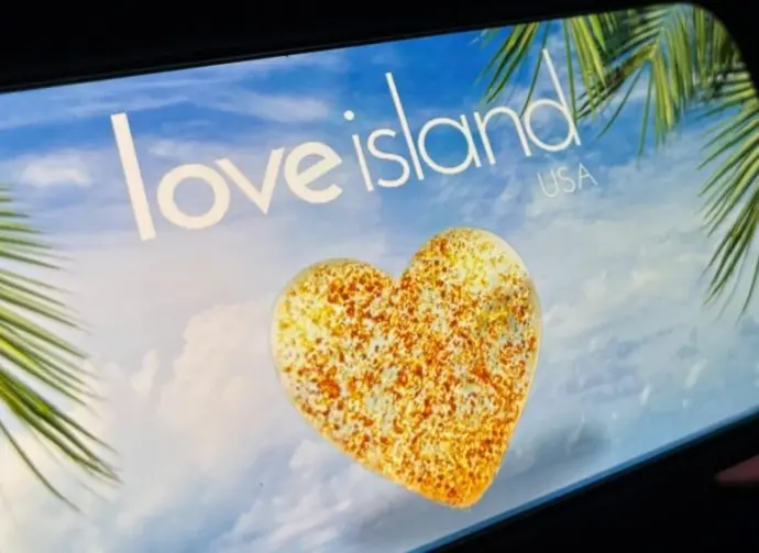 '2025 Love Island'' shown on a smart phone. is a reality dating show that originated in the UK. The premise involves a group of singles living together in a luxurious villa^ where they couple up Toronto^ Canada - June 5