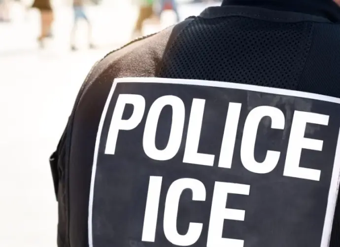 Ice police agent - Officer of Immigration and Customs Enforcement. Close up of POLICE ICE on back of stab proof vest worn by DHS Department of Homeland Security police officer at the scene of incident