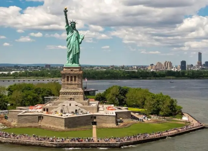 New York City with statue of liberty photo from drone. Aerial view of statue of liberty skyline in Manhattan. NYC^ NY. Cityscape near statue of liberty. Famous statue of liberty of New York.