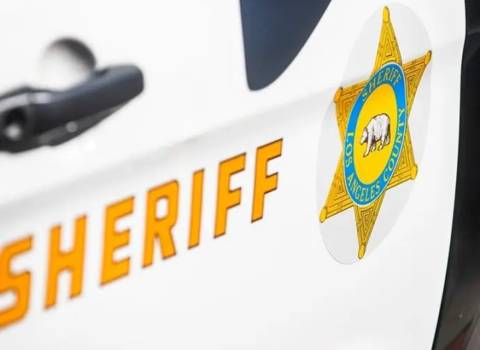 Close-up of a Los Angeles County Sheriff's Department badge and lettering on the side of a patrol vehicle. 2024-11-15 Los Angeles USA