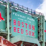View of the historic architecture of the Famous Fenway Park Stadium in Boston^ MA^ USA showcasing its huge sign^ old brick walls^ and entrances on Lansdowne street. Boston^ MA^ USA - March 1^ 2023