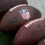 NLF footballs are displayed before an NFL football game between the Los Angeles Rams and the Seattle Seahawks at SoFi Stadium Sunday Nov. 16^ 2025^ in Inglewood^ Calif.