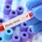 Doctor holding a test blood sample tube with Ebola virus test on the background of medical test tubes with analyzes.