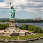 New York City with statue of liberty photo from drone. Aerial view of statue of liberty skyline in Manhattan. NYC^ NY. Cityscape near statue of liberty. Famous statue of liberty of New York.