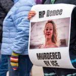 Protest sign honoring Renee Nicole Good during demonstration. Toronto^ Canada - January 10^ 2026.