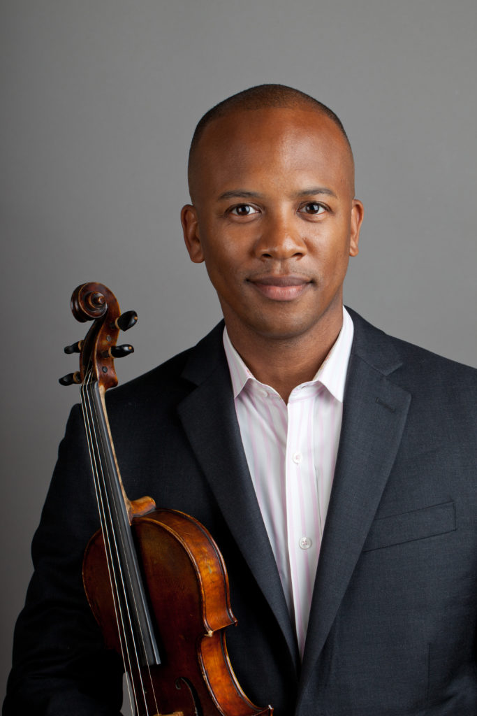 Portrait of man in suit jacket holding violin