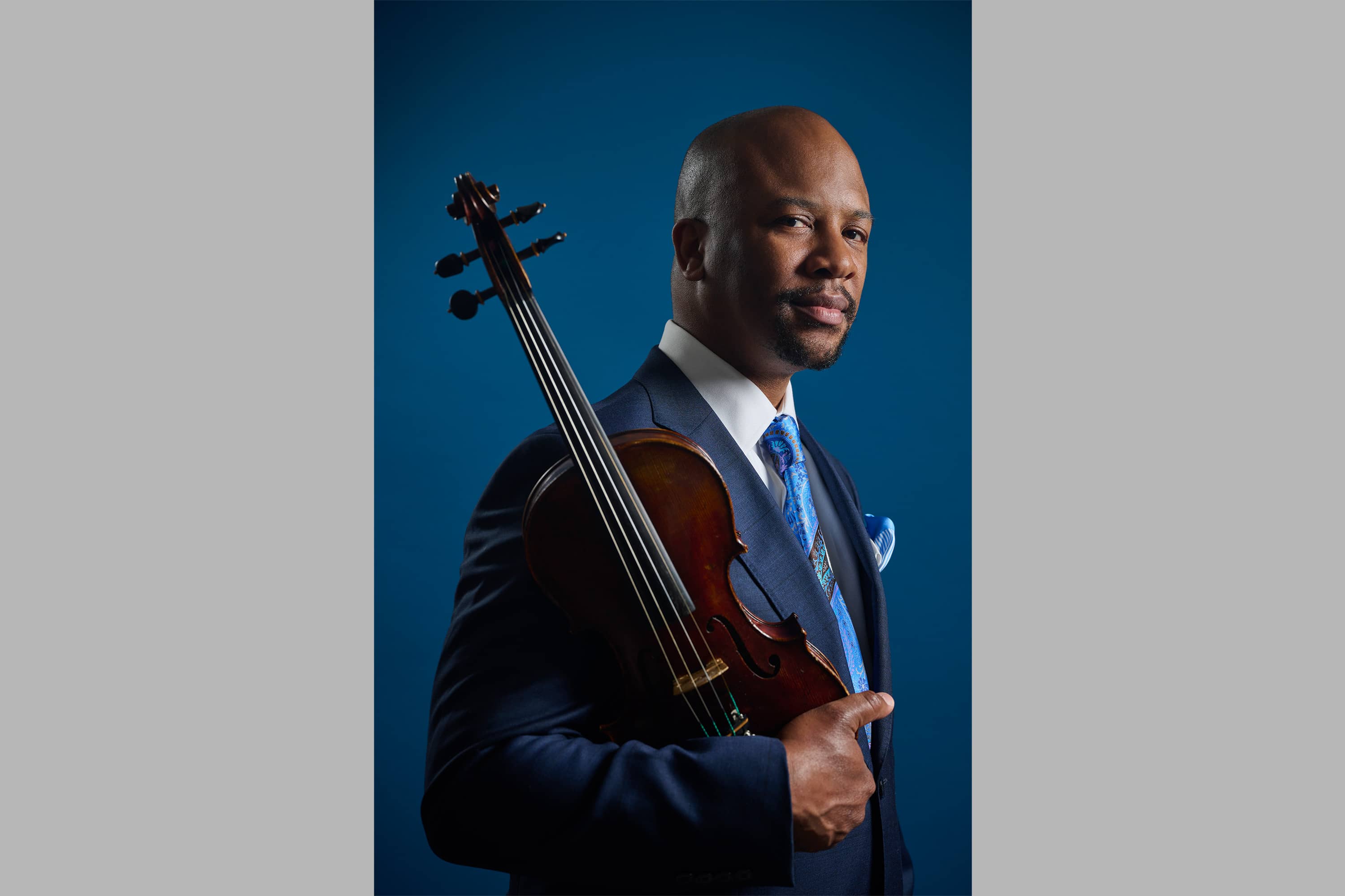 Portrait of Dr. Quinton Morris, holding a violin