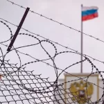 The concept of European and US sanctions pressure on the Russian Federation government. flag of the Russian Federation in barbed wire^ sanctions and aggression of Russia. Russian prison