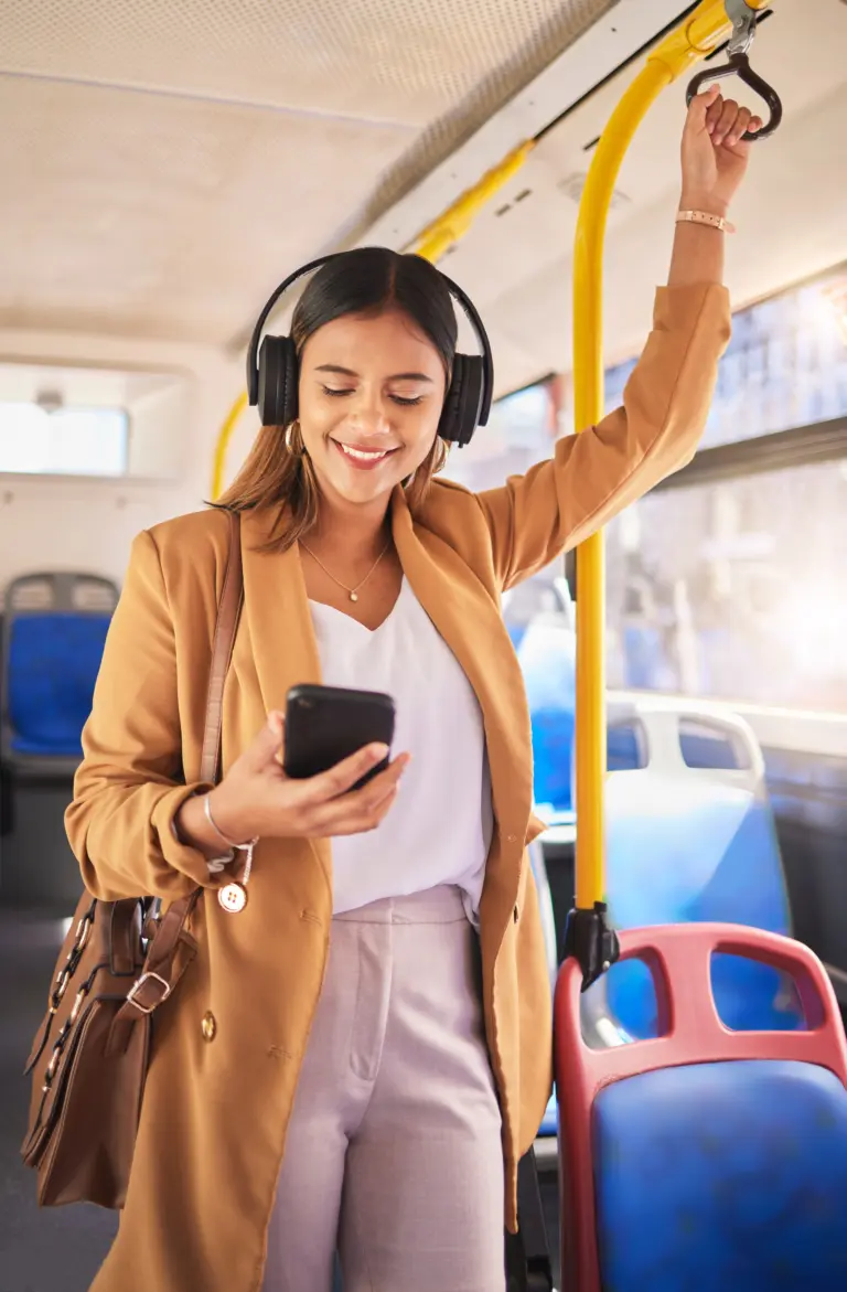 woman listening to podcast in bus