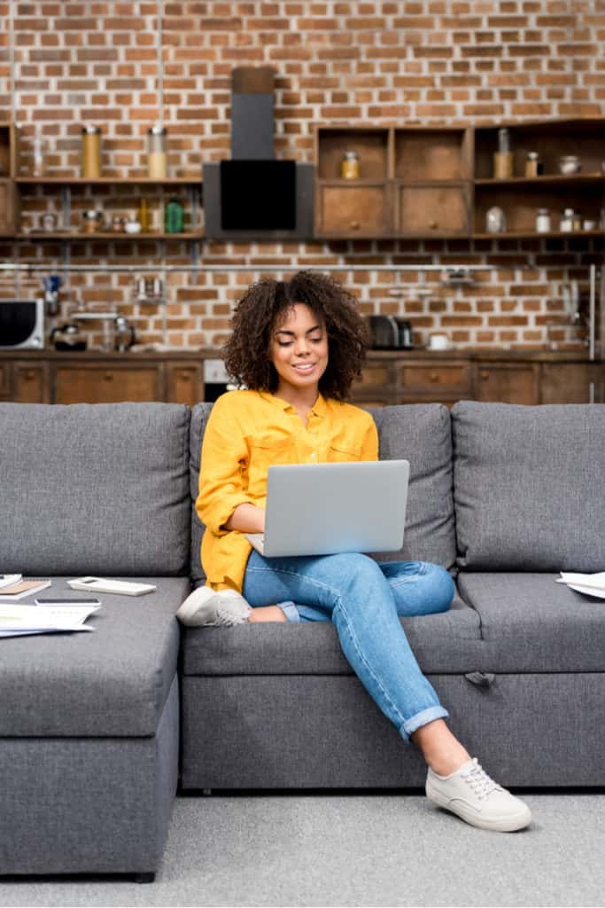 woman sitting on a couch working from home