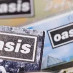 London^ UK - August 27 2024: Oasis band cds. Oasis are a popular rock band from the 1990's britpop era