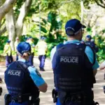 Crime in Sydney Australia. Close up of a NSW Police officers uniform sleeve patch and his communication device. Sydney^ NSW Australia - October 6 2024