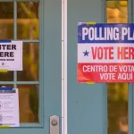 Signs on polling place door during voting on presidential election day in northern Virginia. ARLINGTON^ VIRGINIA^ USA - NOVEMBER 3^ 2020