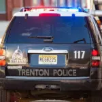 Municipal police car with flashing lights on the road at day Trenton^ NJ^ USA - Jan. 18^ 2021