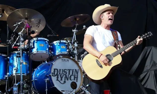 Dustin Lynch performs during the 'Kick The Dust Up' Tour at Vanderbilt Stadium on July 11^ 2015 in Nashville^ Tennessee.