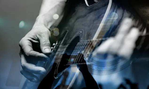 country artist/Guitarist with the audience in a double exposure