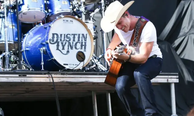 Dustin Lynch performs during the 'Kick The Dust Up' Tour at Vanderbilt Stadium on July 11^ 2015 in Nashville^ Tennessee.