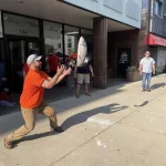 Salmon-throwing contest for charity. Don't drop it or you'll get slapped with the salmon!