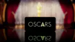 A smartphone displaying the Oscars logo against a blurred awards ceremony background. January 13^ 2025