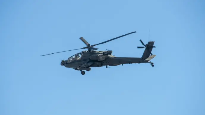 Army Apache AH-64 Helicopter during the Dragoon Ride Exercise on March 22^ 2015 in Vilnius^ Lithuania. The Boeing AH-64 Apache is a four-blade^ twin-turboshaft attack helicopter. VILNIUS - MAR 22