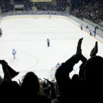 hockey fans applaud at ice hockey stadium