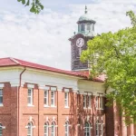 Clock Tower Atop White Hall: Historic clock tower atop White Hall on the campus of Tuskegee University. TUSKEGEE^ ALABAMA - MARCH 28^ 2019