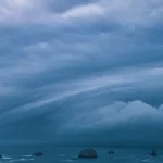 Storm clouds from bomb cyclone over sea stacks in the ocean at the Oregon Coast.