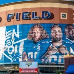 Horizontal^ medium closeup of "Ford Field" Detroit Lions' football field stadium's exterior facade brand and logo signage on a sunny day. Detroit^ MI USA - September 15^ 2021