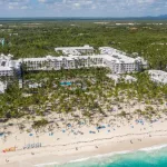 Aerial view from drone on RIU resort building on caribbean beach in Punta Cana^ Bavaro^ Dominican Republic - 8 April 2022