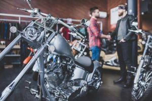 men talking in front of motorcycyles