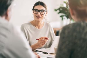 woman conversing with couple
