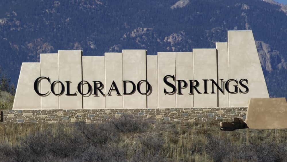 Colorado Springs city entry monument with Pikes Peak in the background. Colorado Springs, CO