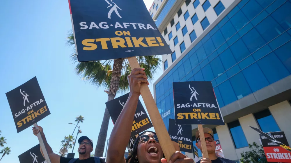 Striking actors walk with pickets outside Sunset Bronson studios in Los Angeles; July 14, 2023.