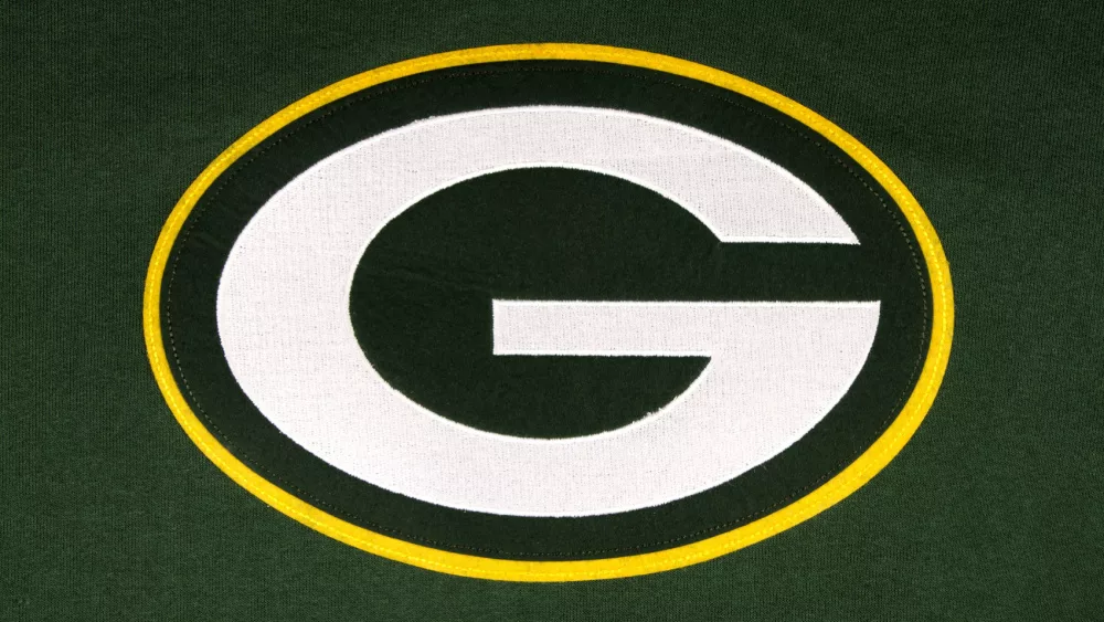 The Green Bay Packers emblem on green background