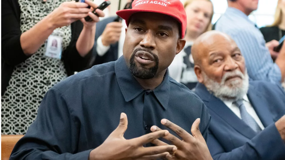 Kanye West speaks with US President Donald J. Trump in the White House Oval Office, 2018