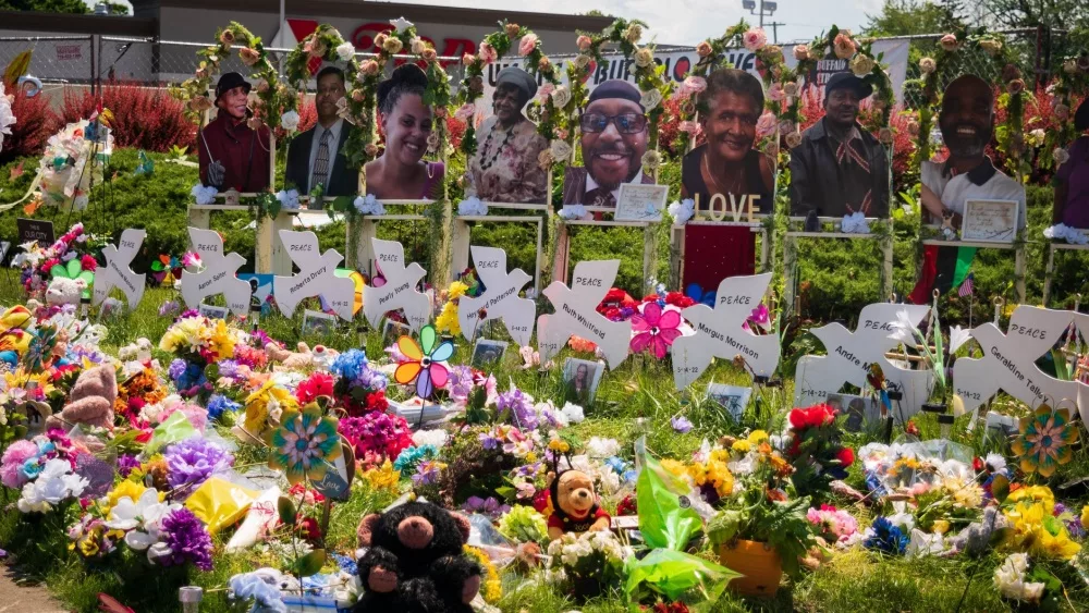 Memorial of flowers, dove cut-outs and pictures of the African American victims of the mass shooting in Buffalo NY at a Tops supermarket. Buffalo, New York, USA- June 11, 2022