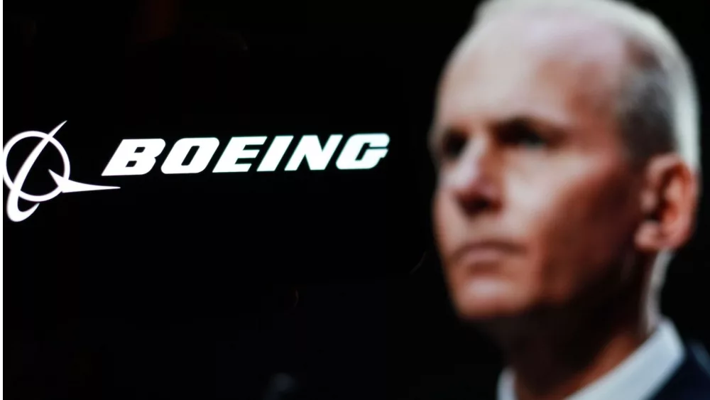 Logo of the Boeing Company, with CEO Dave Calhoun in the background