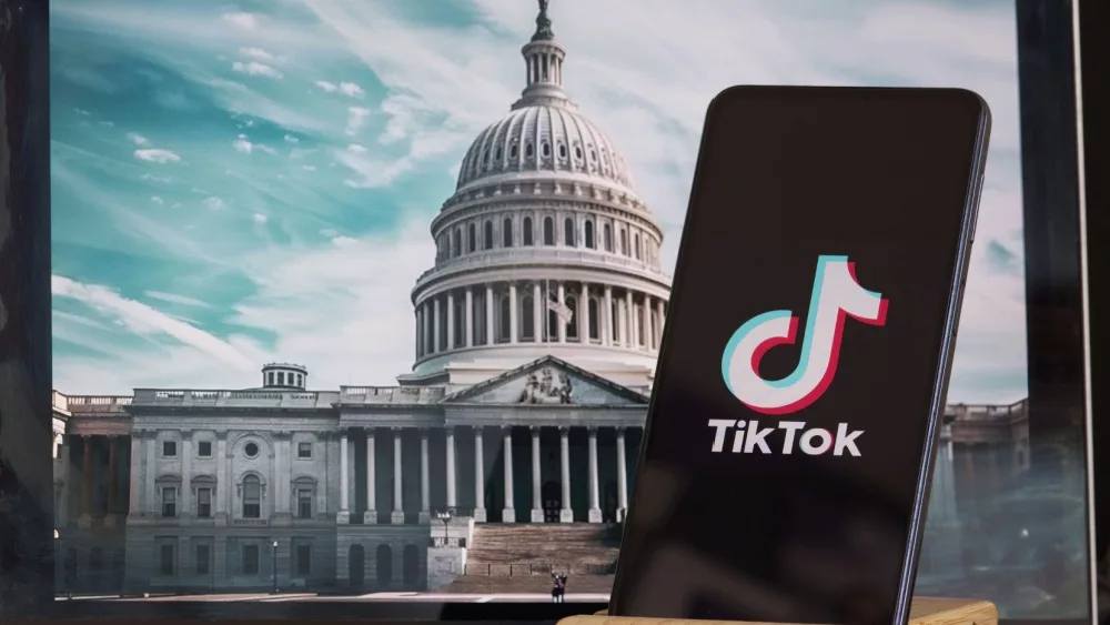 TikTok sign in the foreground, while American Congress building is blurred in the background, concept for TikTok ban in the United States