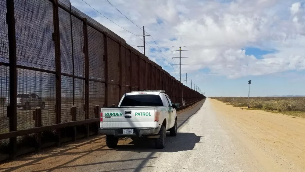 U.S. Customs and Border Patrol vehicle drives along the U.S.-Mexico border. El Paso, Texas / USA - March 7, 2020