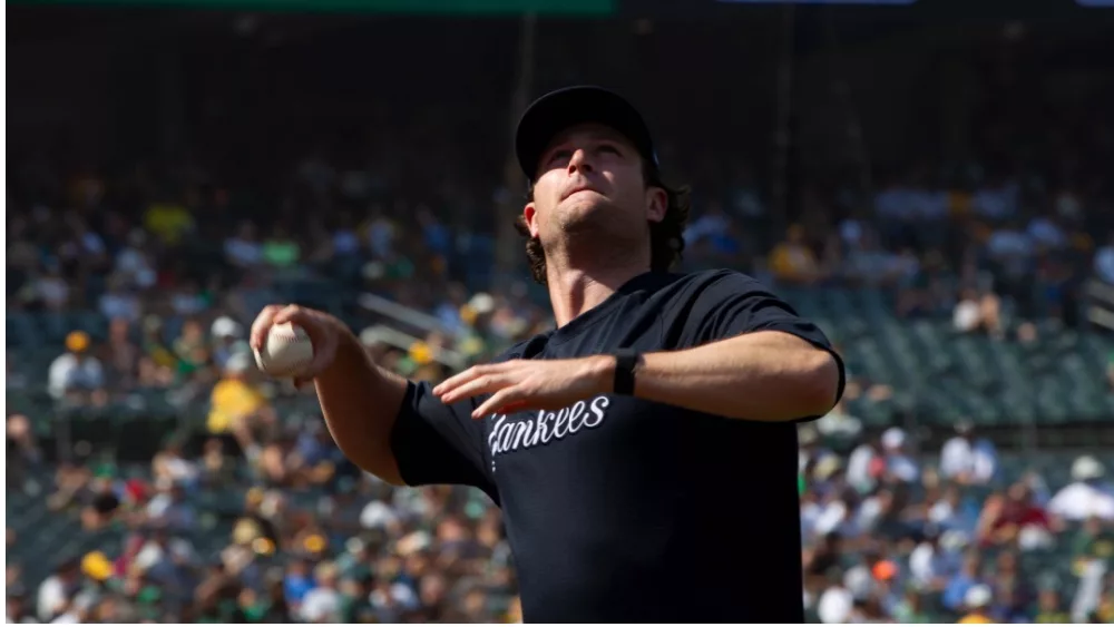 New York Yankees' Gerrit Cole throws a foul ball over the net into the stands during a game against Oakland Athletics at RingCentral Coliseum. Oakland, California - August 28, 2021